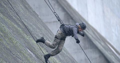 JoJo Siwa scaling a dam on 'Special Forces' Season 2