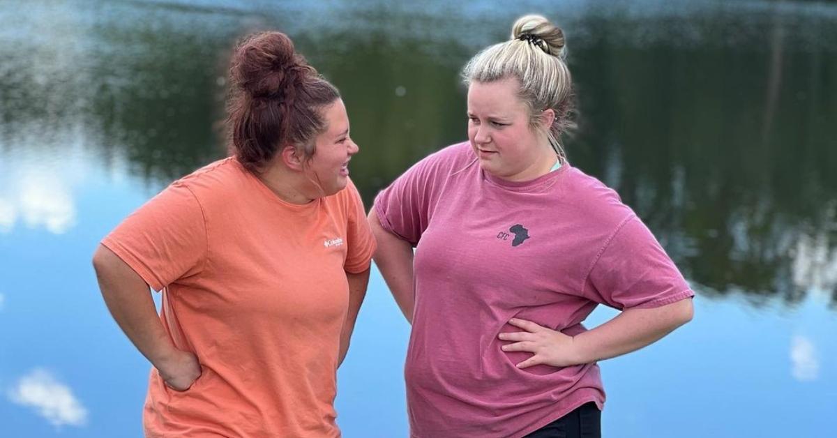 Jessica and her girlfriend, Shyann, stend outside together by a pond