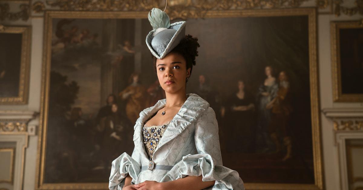 India as 'Queen Charlotte' on Netflix standing in front of painting