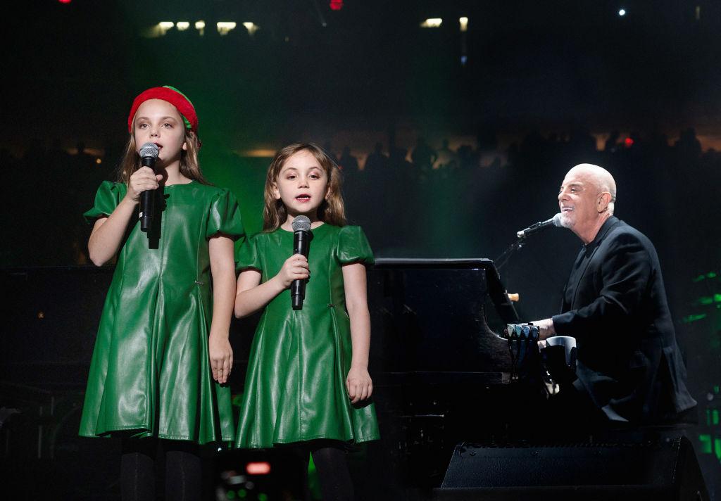 Billy Joel performing with his two youngest daughters, Della and Remy