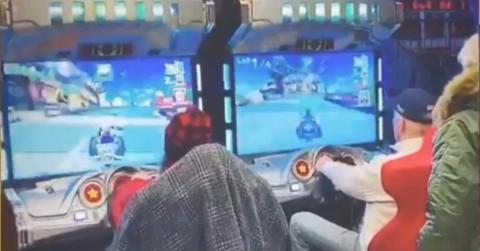 President Joe Biden playing the arcade version of Mario Kart.