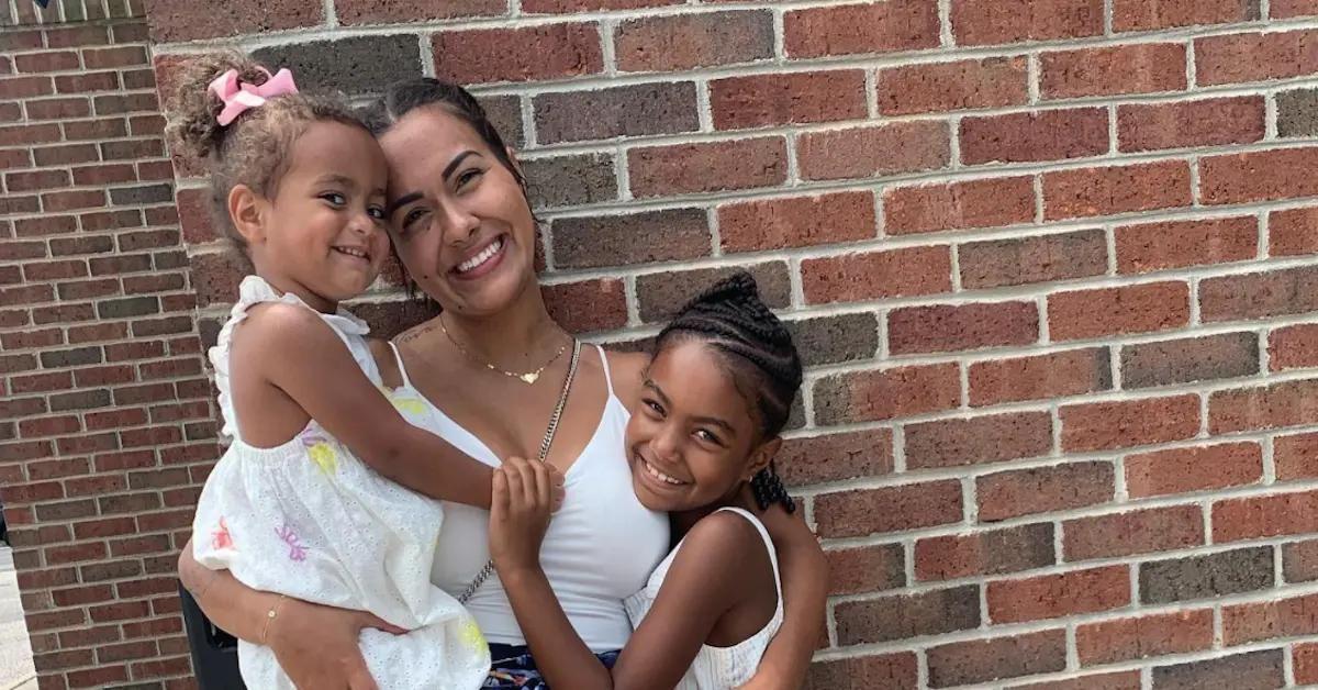 Briana DeJesus smiles alongside her daughters.