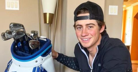 Golf influencer Garrett Clark poses with golf clubs.