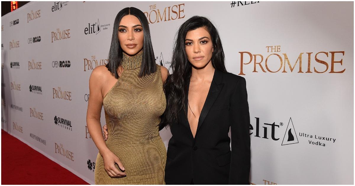 (l-r): Kim Kardashian and Kourtney Kardashian embracing at a red carpet event. 