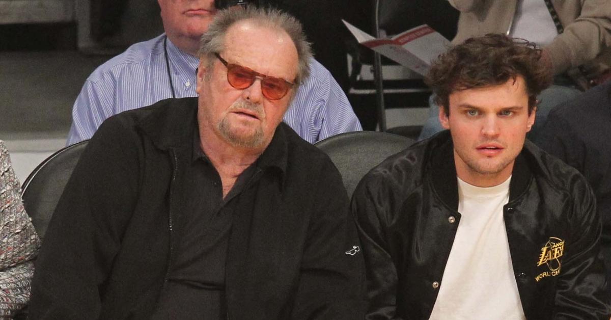 Jack Nicholson and his son Ray sit court side at a basketball game.