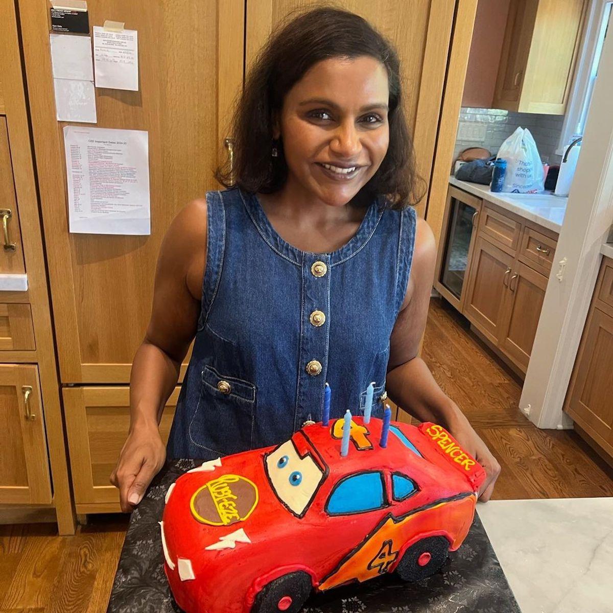 Mindy Kaling holds a giant Cars-themed cake for her son Spencer