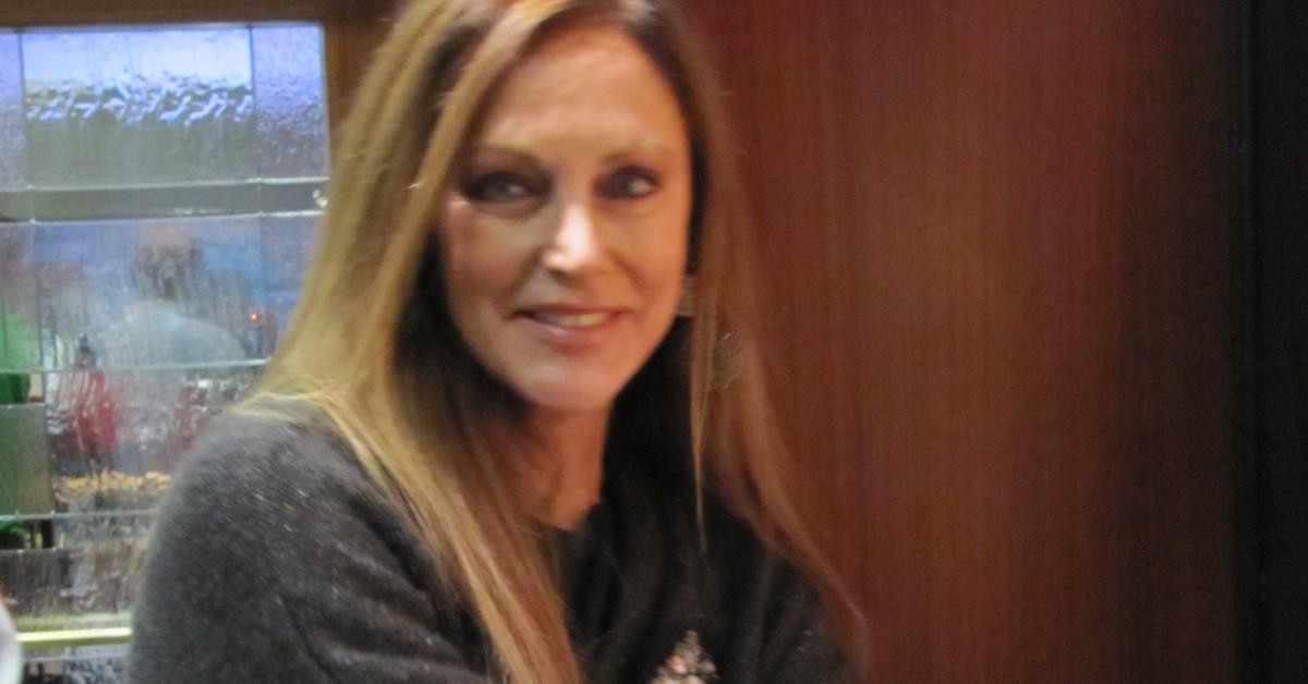 Peggy Fleming holding a gold medal