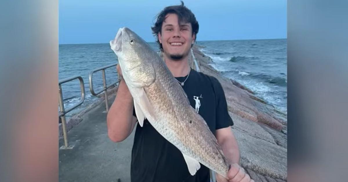 Caleb Harris holds up a fish he caught