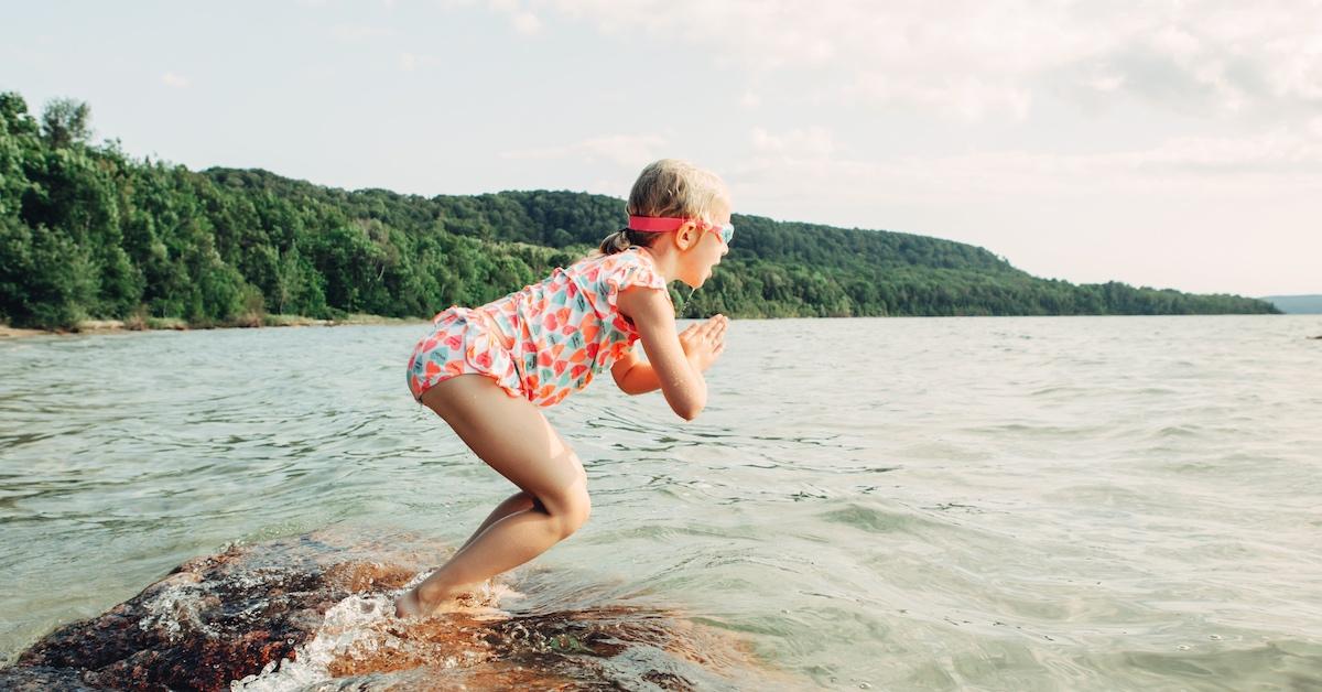 A child jumping into a body of water