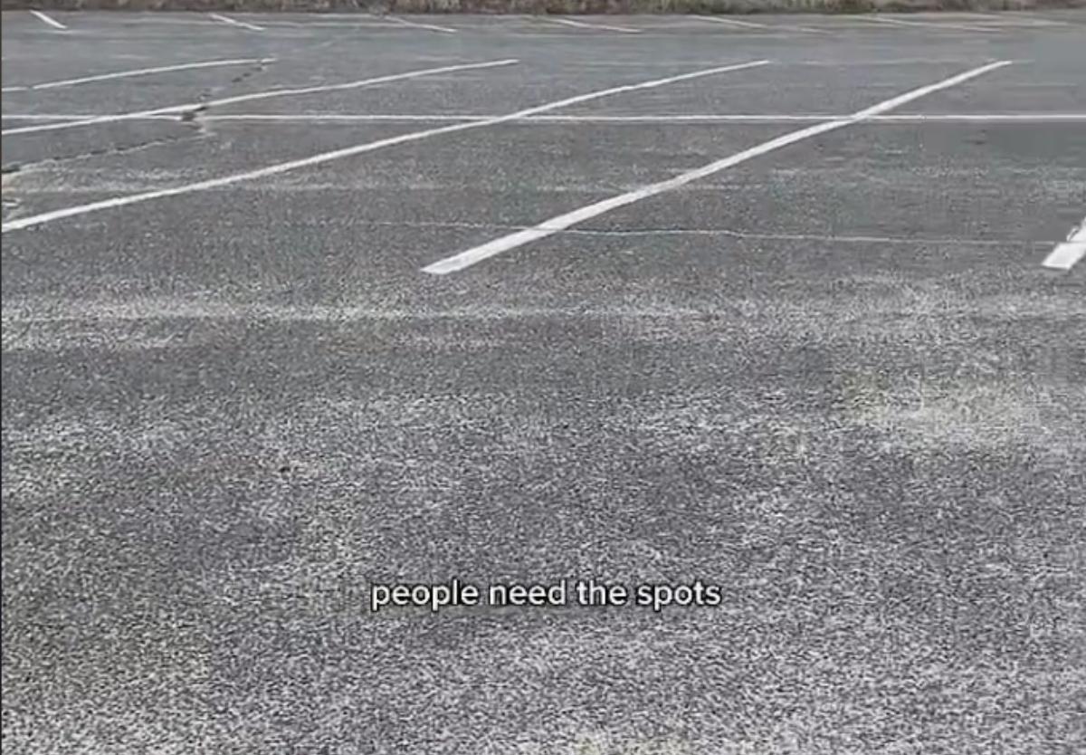 A man complains about person parking in an empty parking lot