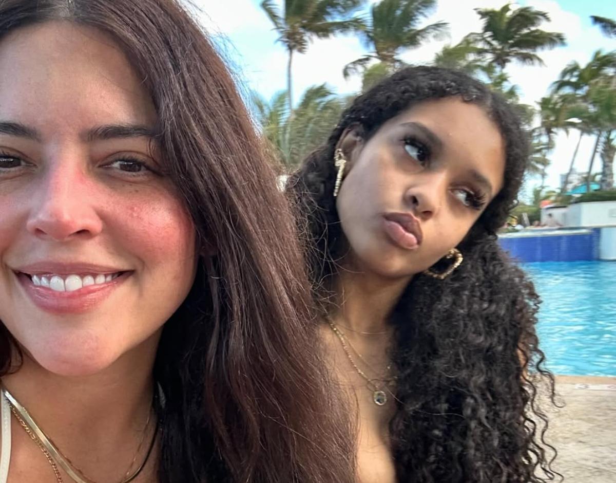 Denise Bidot with her daughter by a pool