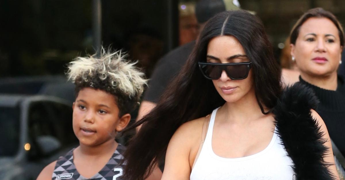 (l-r): Saint West and Kim Kardashian walking outside