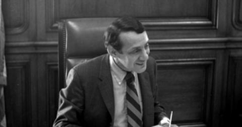 Harvey Milk sitting at a desk.