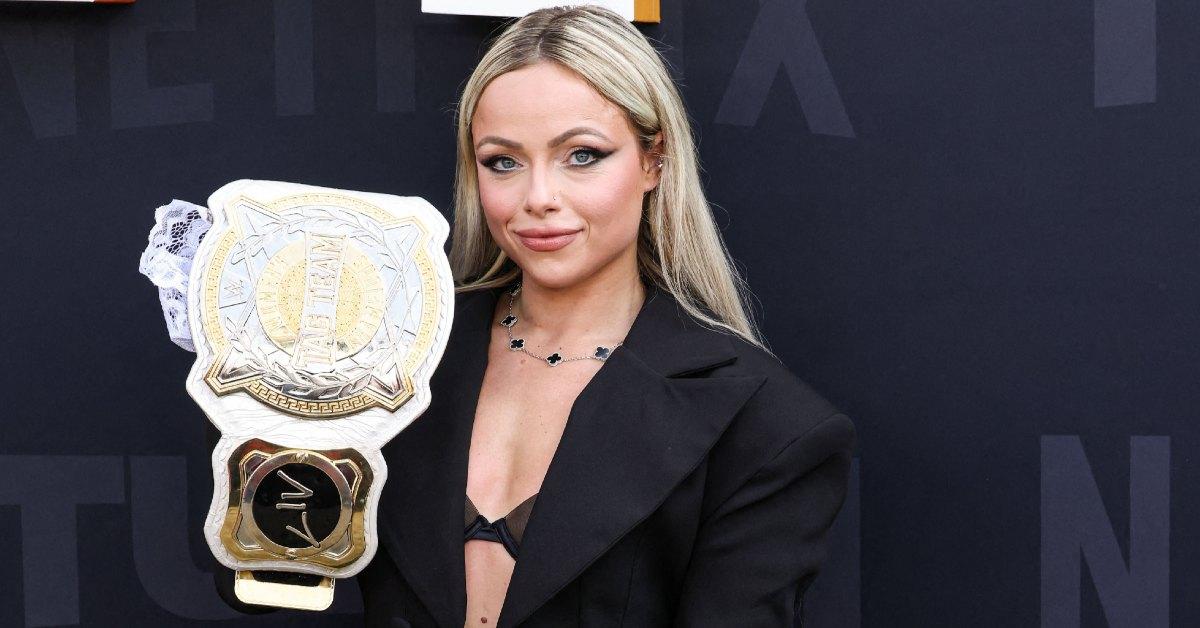 Liv Morgan holding her belt at a Netflix event.