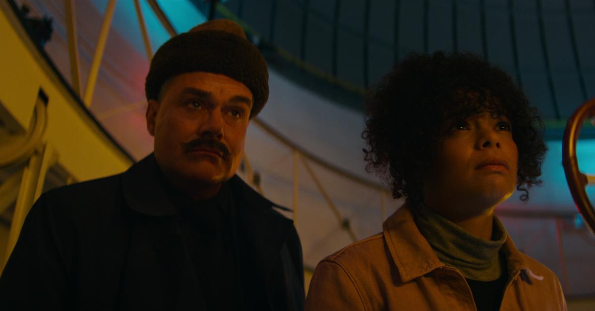 Neil Mullarkey as Mustache Man, Lydia West as Reilly Clayton in episode 106 of The Pentaverate.