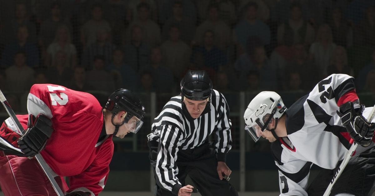 Ice hockey players facing off - stock photo