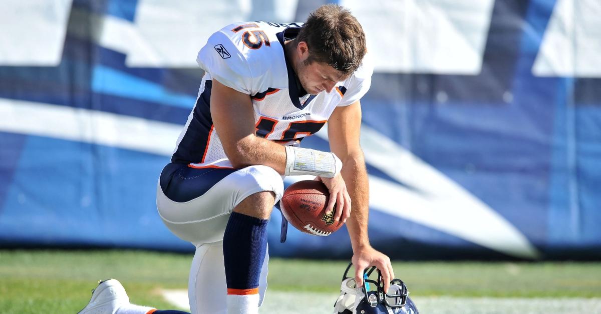 Tim Tebow kneels on the field during a 2012 game.