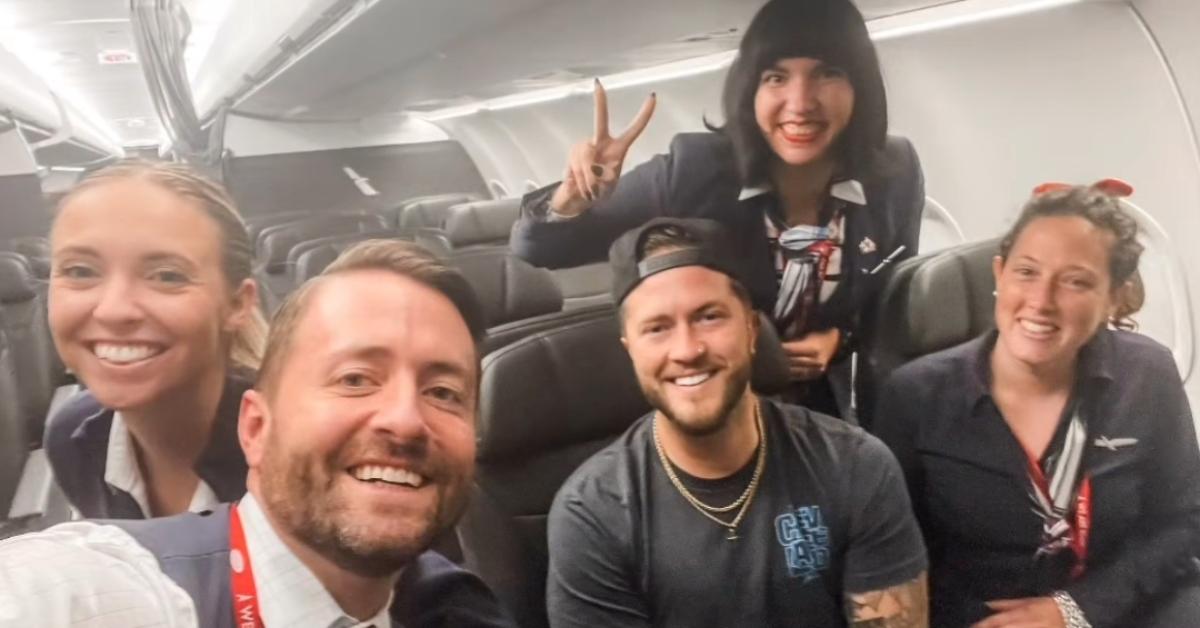 The flight attendants pose with their sole passenger on flight