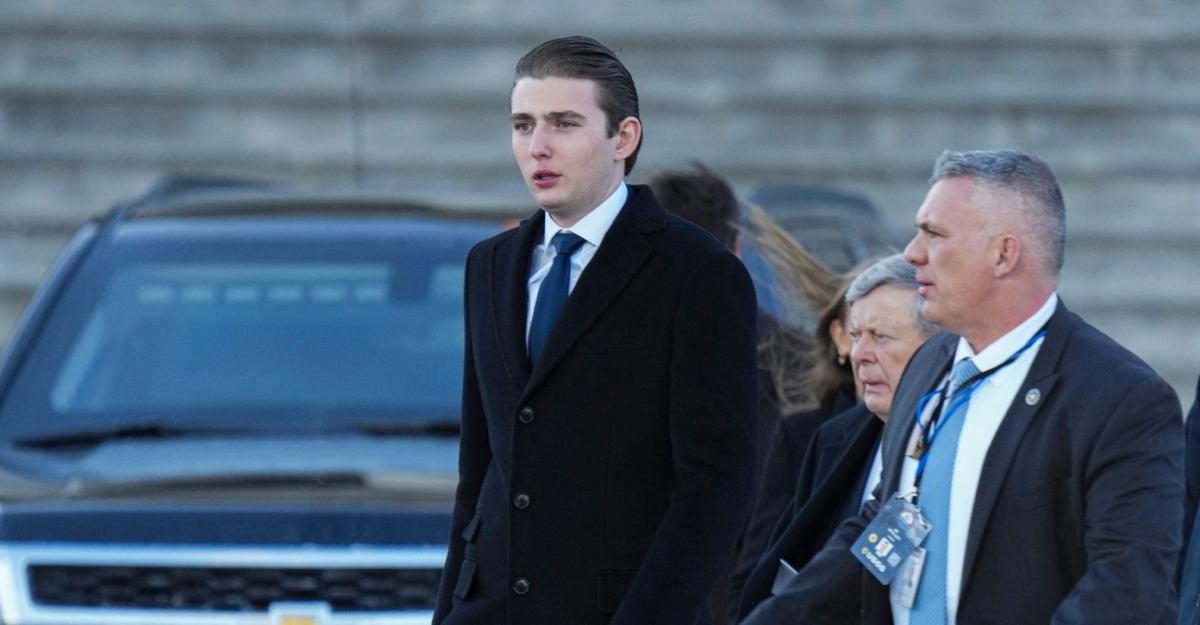 Barron Trump wears a suit on a cold day