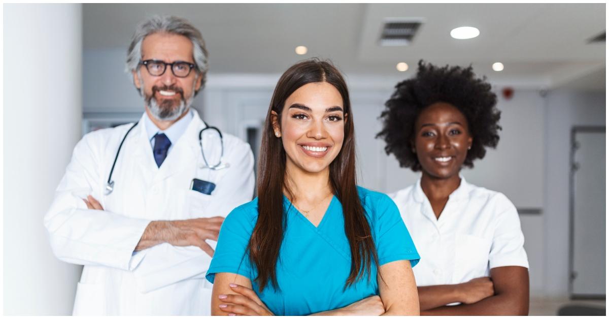 (l-r): Doctors and nurses in an office.