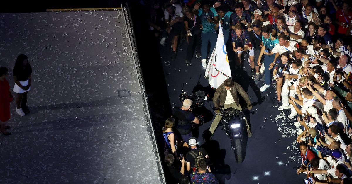 Tom Cruise rides a Motorbike with the IOC Flag during the Closing Ceremony of the Olympic Games Paris 2024 