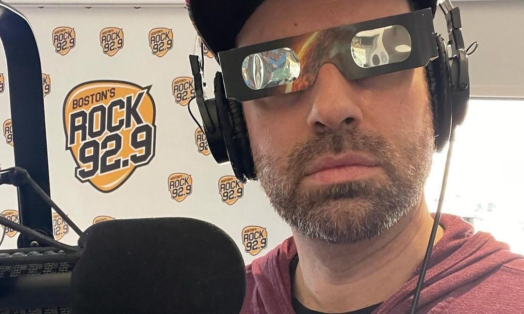 Adam 12 of ROCK 92.9 wearing eclipse glasses