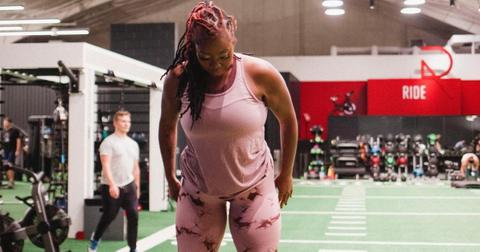 Ashley Michelle from 90 Day Fiance in a pink tank top and leggings in a gym