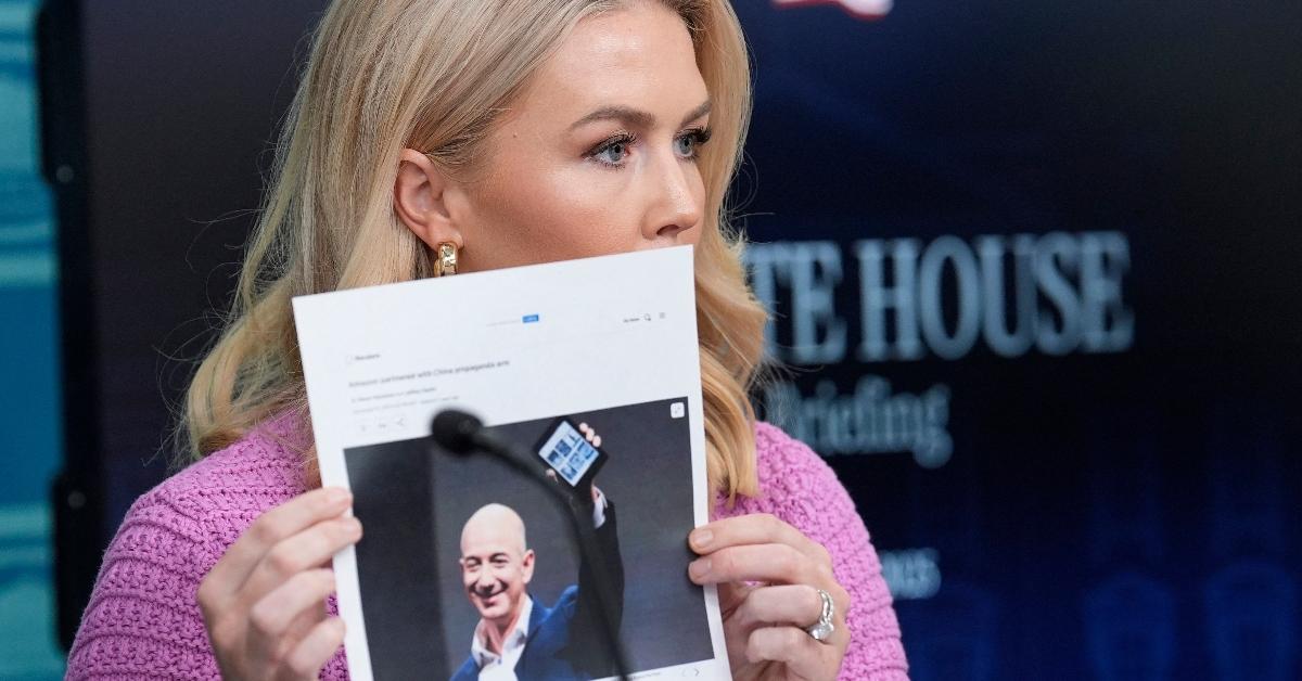 White House Press Secretary Karoline Leavitt holds up a photo of Jeff Bezos