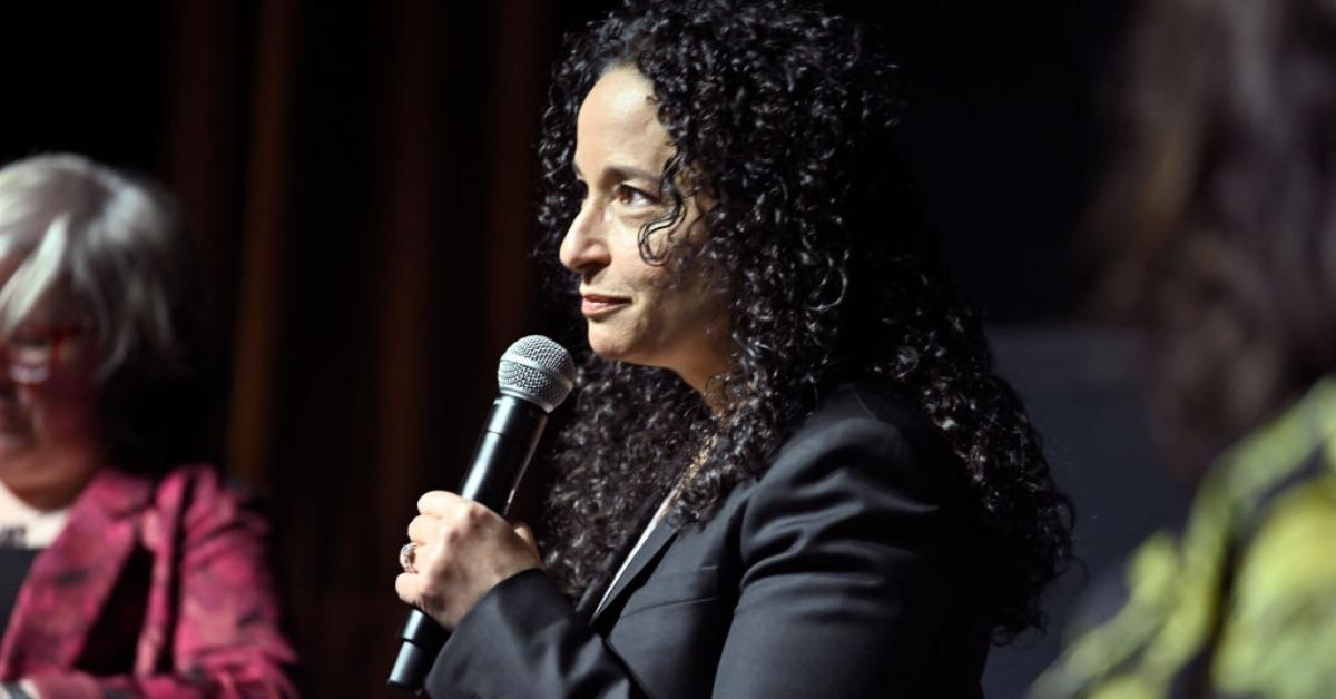 'The Diplomat' creator Debora Cahn at an event holding a microphone.