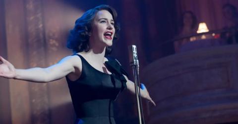 Midge (Rachel Brosnahan) in a elegant black dress as she performs a standup routine