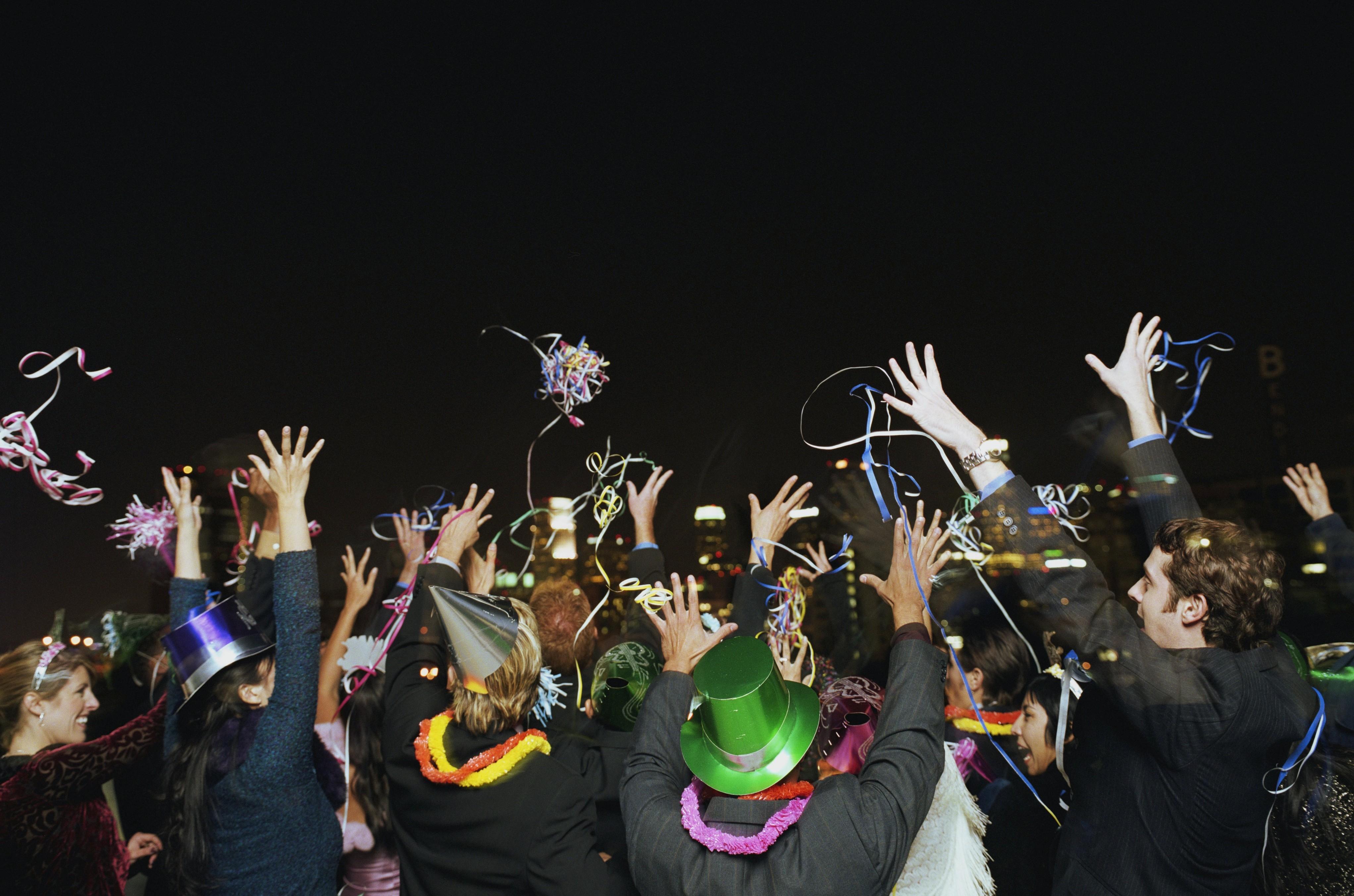 People celebrating on rooftop at New Year's Eve party