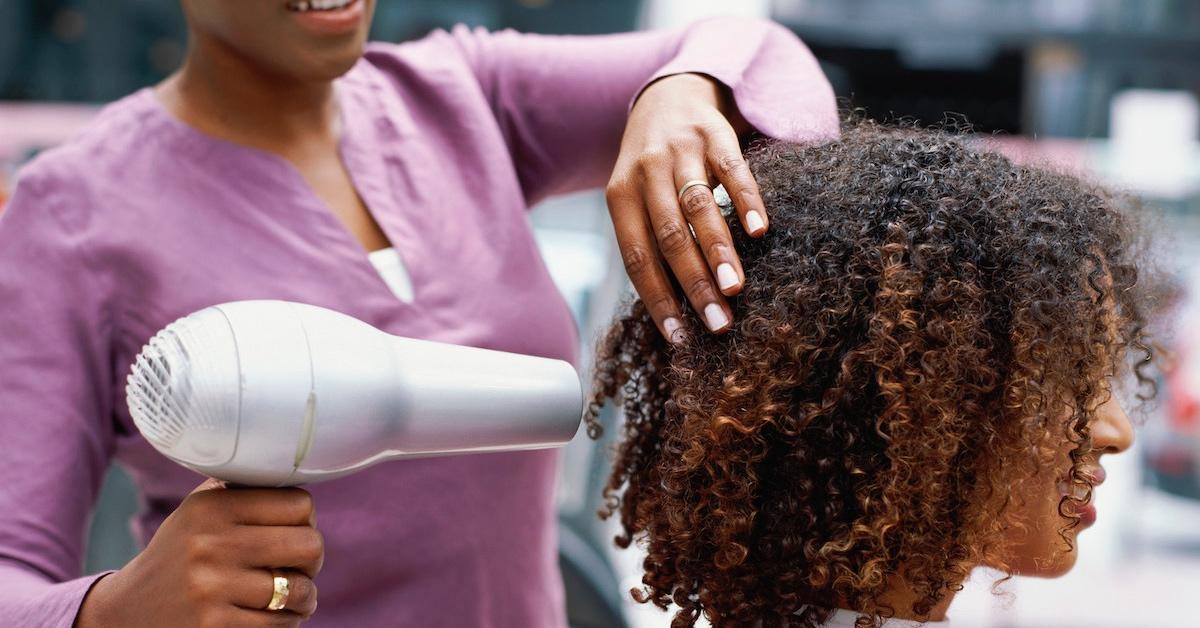 A woman having her hair dried with a hair dryer