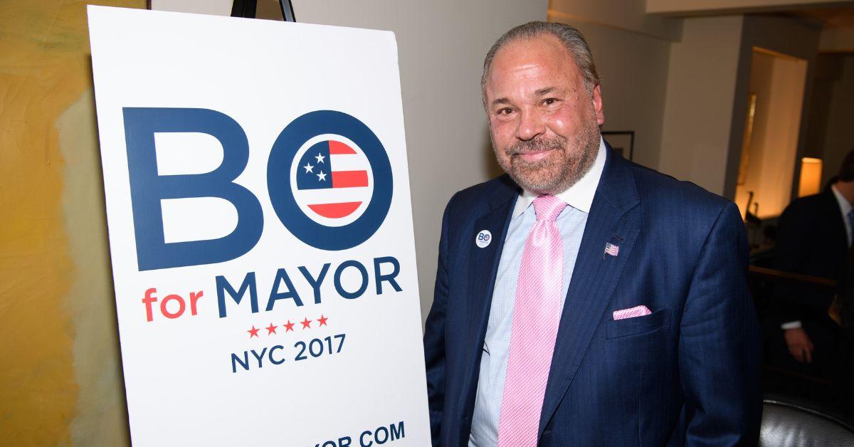 Bo Dietl posing next to his mayor sign in 2017.