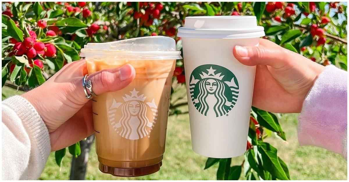 Two people holding Starbucks drinks outside