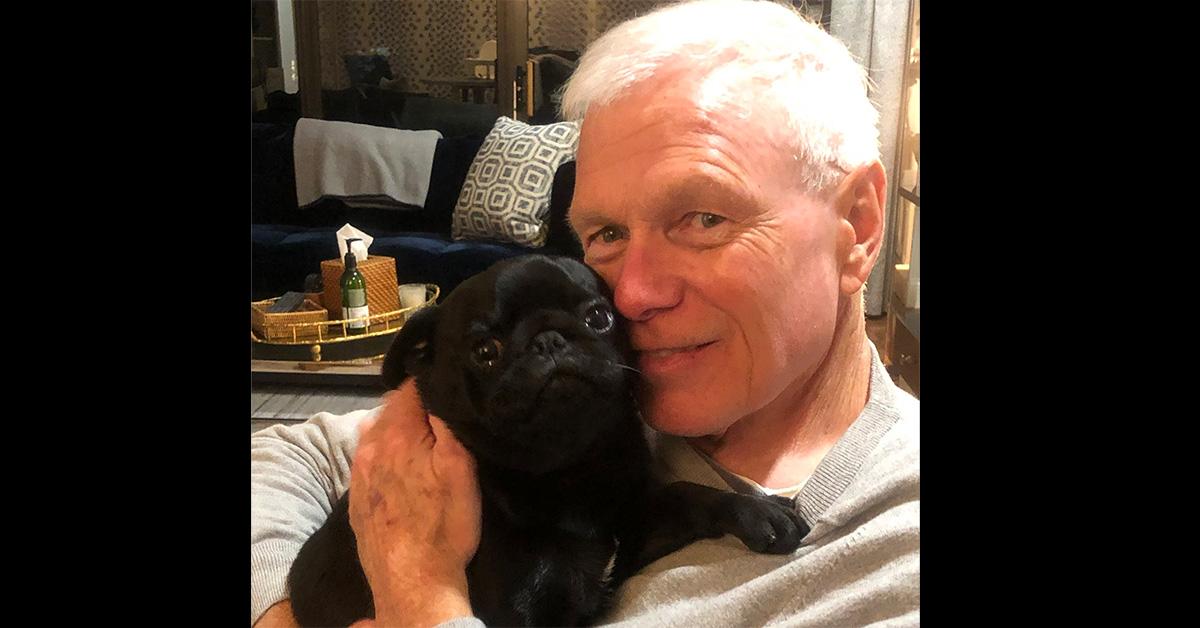 Howie Carr holding a black pug. 