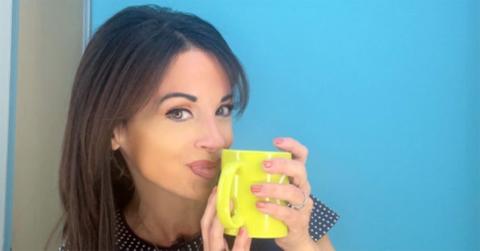 Hollie Strano holding a yellow coffee cup.