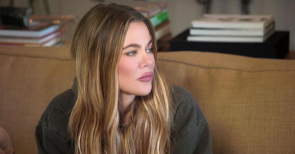 Khloé Kardashian in 'The Kardashians' looking solemn on sofa