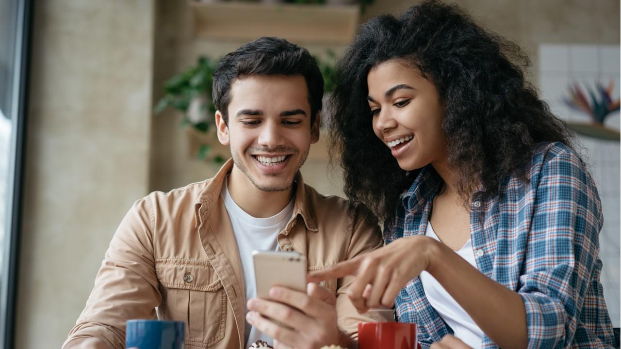 A couple looking at Instagram on a smartphone