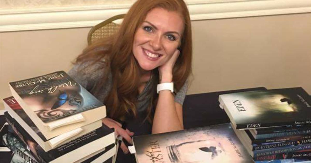 author jamie mcguire surronding by books she wrote