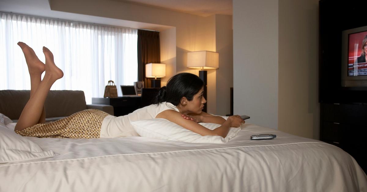 A woman on a hotel room bed