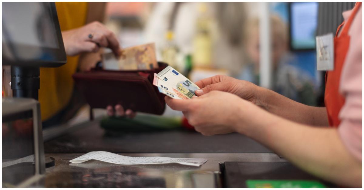 A cashier holding a customer's money