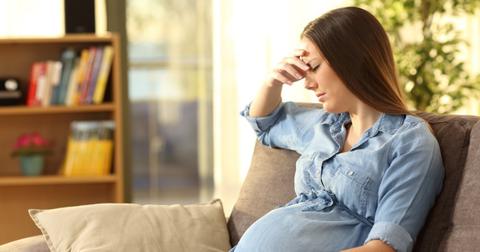 worried pregnant woman at home picture id