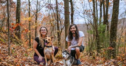 MoistCr1TiKaL and girlfriend Tracy Tiana pose with their dogs in the woods