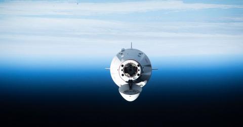 The Dragon Spacecraft floating above Earth.