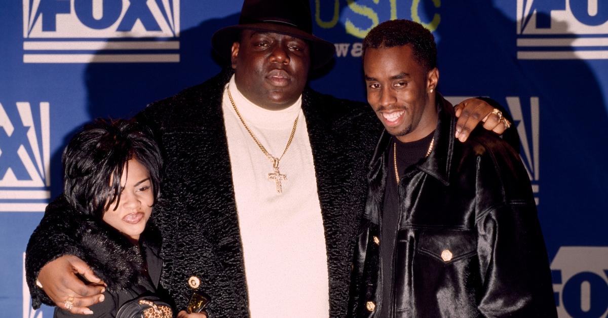 Rapper Notorious B.I.G. AKA Biggie Smalls (Christopher Wallace) joined by Sean (Puffy) Combs and Lil' Kim receives Billboard Music Award on December 6, 1995 at The Coliseum in New York City, New York. (Photo by Larry Busacca/Getty Images)