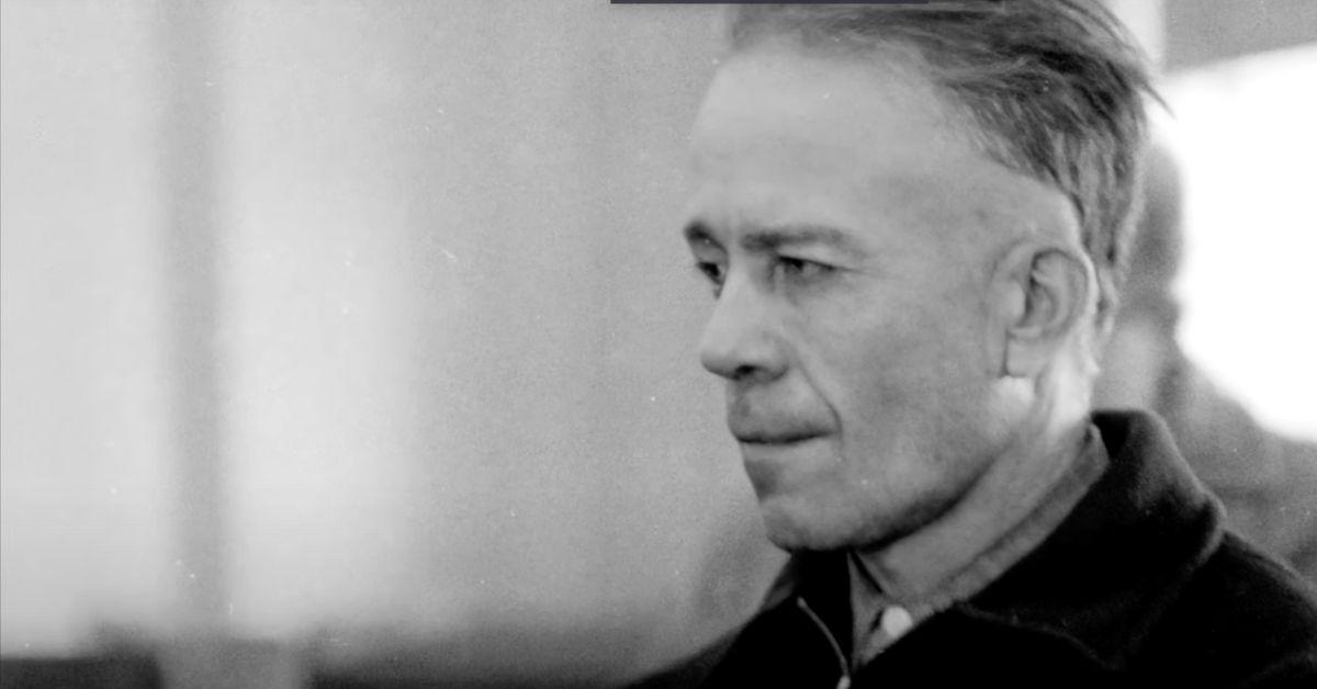 Ed Gein in a shirt and jacket. 