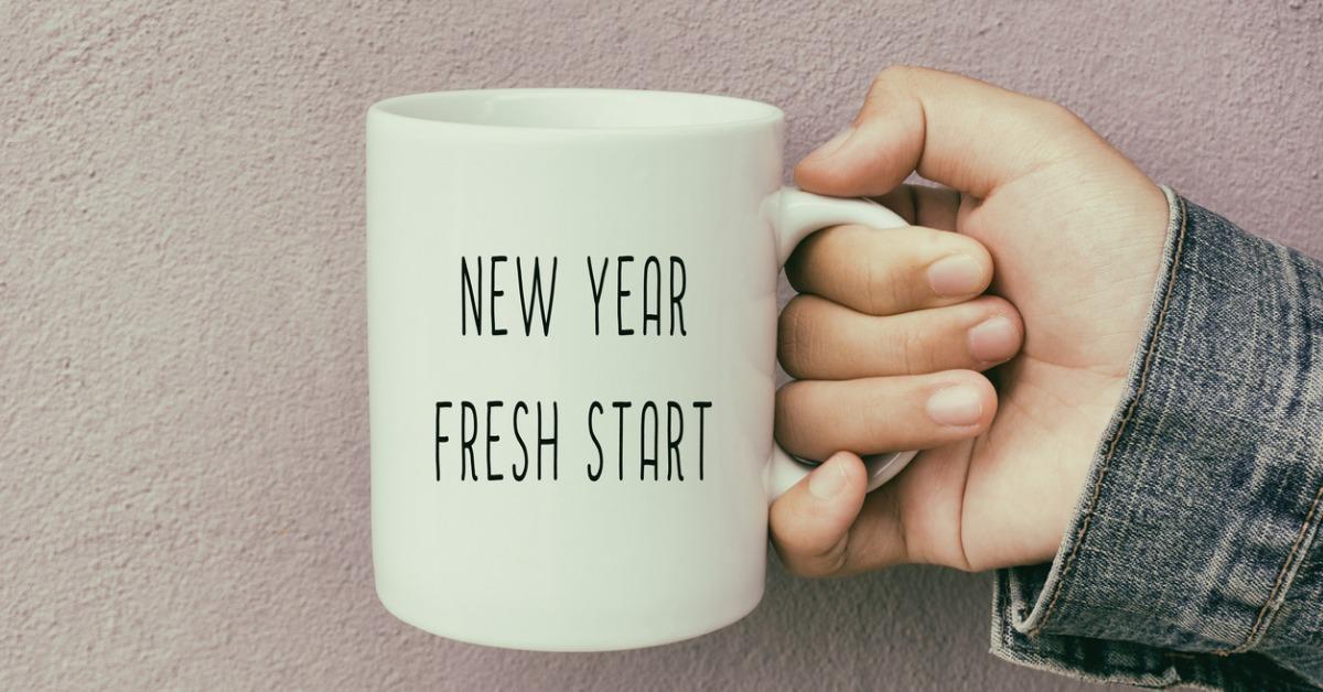 hands holding a coffee mug with text new year fresh start picture id