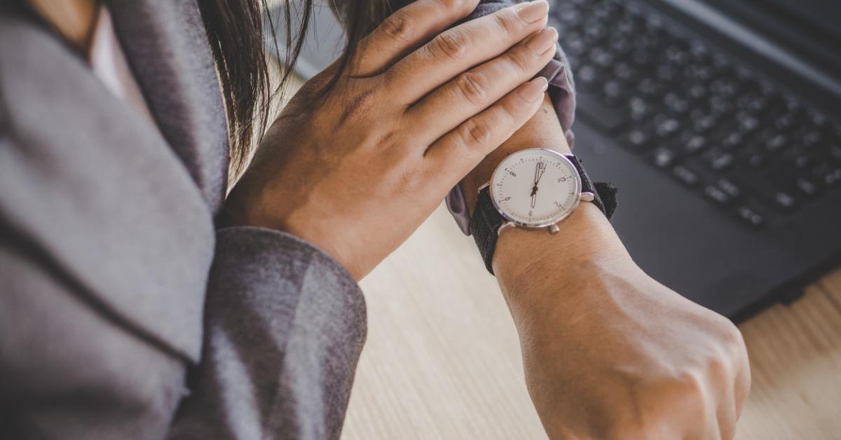 businesswoman checking the time on watch picture id