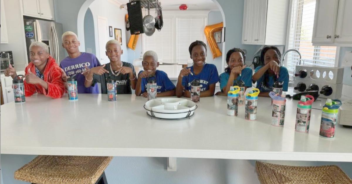 The Derricos children sitting at the kitchen island in their new home.