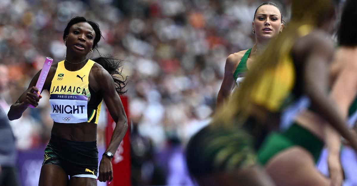 Jamaica's Andrenette Knight runs with the baton in the women's 4x400m relay heat of the athletics event at the Paris 2024 Olympic Games at Stade de France in Saint-Denis, north of Paris, on August 9, 2024. (Photo by Jewel SAMAD / AFP) (Photo by JEWEL SAMAD/AFP via Getty Images)